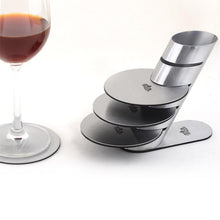 Load image into Gallery viewer, stainless steel coasters on a stand and a glass of wine