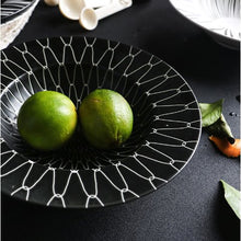 Load image into Gallery viewer, DEJAVU DINNERWARE BLACK WITH WHITE GEOMETRIC PATTERN PRINTED AND 2 GREEN FRUITS PLACED IN THE CENTER