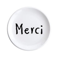 Load image into Gallery viewer, The word Merci printed in black on a white ceramic plate