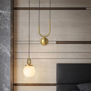 2 Madorne pendant lights hanging on a ceiling in a bedroom