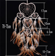Load image into Gallery viewer, brown feathers on a dreamcatcher with white heart shaped rings and size specifications