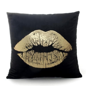 Image of lips in gold printed on a black throw cover