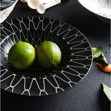 Load image into Gallery viewer, DEJAVU DINNERWARE BLACK WITH WHITE GEOMETRIC PATTERN PRINTED AND 2 GREEN FRUITS PLACED IN THE CENTER 