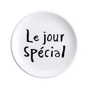 le jour special printed in black on a white ceramic plate