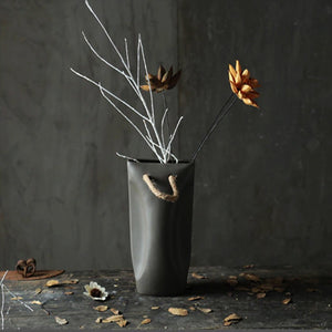 luna dark grey planter pot with artificial stems and yellow flower