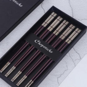 5 pairs of maroon with white colored ends chopsticks in a black box