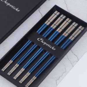 5 pairs of blue with white colored ends chopsticks in a black box
