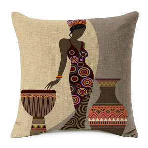 african lady posing near a drum and a large water jar printed on a cushion cover