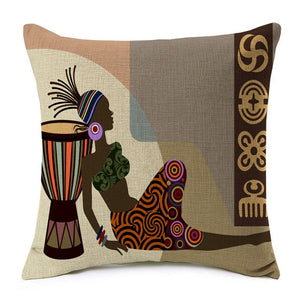 african lady sitting on the floor against a drum printed on a cushion cover