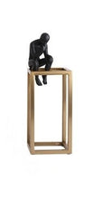 Load image into Gallery viewer, decorative figurine of a man statue sitting on a gold rectangular tower