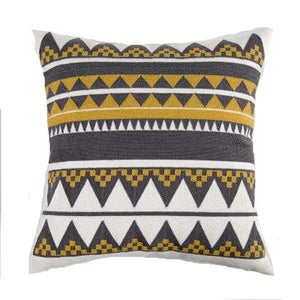 cushion cover with grey, mustard yellow, black and white in geometrical patterns