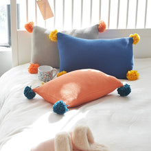 Load image into Gallery viewer, 3 cushion covers in grey, blue and orange lying on a bed