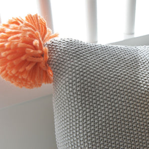 Close up of a grey knitted cushion 