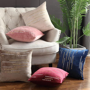 5 luxury cushions in different colours placed on a couch