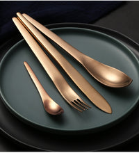 Load image into Gallery viewer, ombre cutlery set of a knife, fork and 2 spoons placed on a black plate