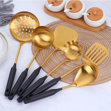 Load image into Gallery viewer, 6 black and gold utensils set on a placemat near cups of tea, sugar and milk