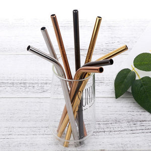 8 assorted stainless steel straws in different colours in a glass