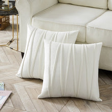 Load image into Gallery viewer, 2 cushions in ivory white from the Nordane cushion collection placed besides a couch