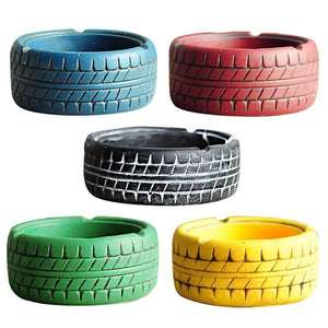 5 tire looking ashtrays in blue, red, black, green and yellow colour