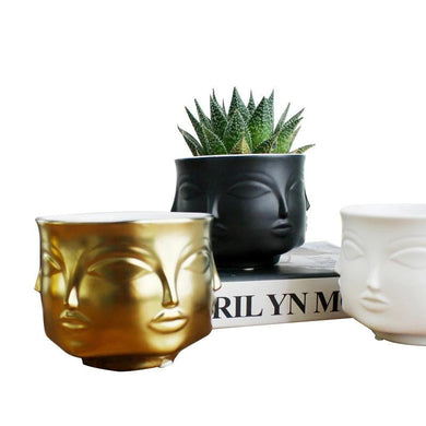 3 Tika face POTS IN GOLD, BLACK AND WHITE AGAINST A BOOK FunkChez